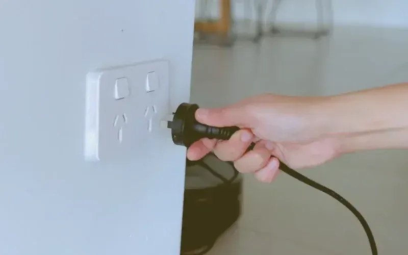 The CoolCove personal cooling device providing instant, refreshing airflow to a relaxed woman working at her desk.